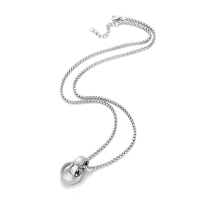Macro shot of interlocked double ring pendants with intricate engraved textures on a silver chain