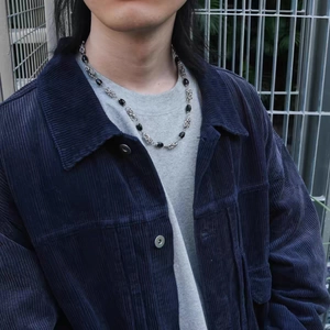 Gothic hip hop cuban link necklace with black beads on a male model outfit