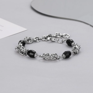 Detailed macro view of hip hop stainless steel Byzantine chain with black beads