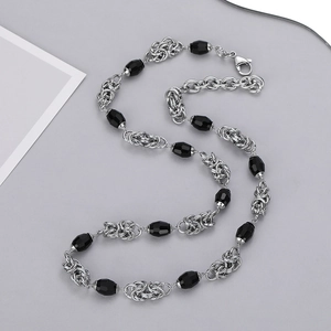 Detail of hip hop Cuban link necklace with black faceted beads and lobster clasp