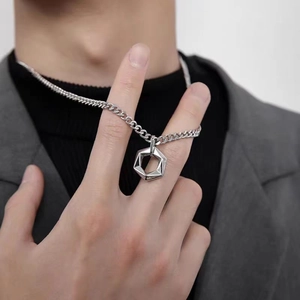 Minimalist silver stainless steel hexagonal nut pendant with cuban chain on male model