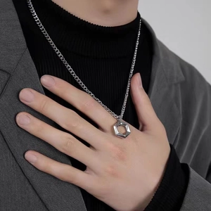 Detailed close-up of a silver hexagonal nut pendant on a titanium steel chain