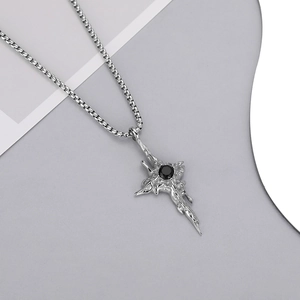 Detail of silver lava texture cross star pendant with black gemstone on square chain