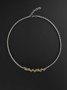 Detail of twisted gold metal wire on silver square chain link necklace with lobster clasp