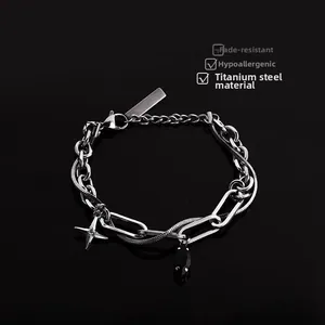 Macro detail of titanium steel chain bracelet with star pendant and lobster clasp