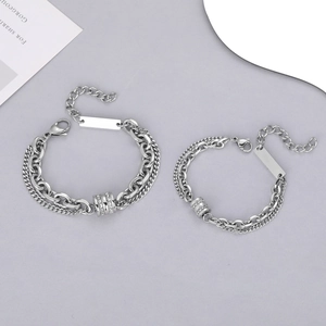 Detail of double-layer titanium steel couple bracelets with polished engraving plates