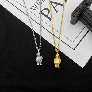 Polished astronaut pendant necklace in gold and silver finish on titanium steel chain