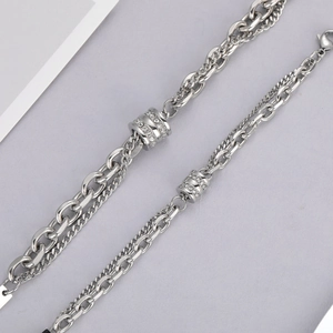 Close-up of double-layer titanium steel bracelets with pavé cubic zirconia cylinders