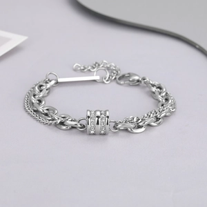 Detail of double-layer titanium steel bracelet with crystal cylinder charm and lobster clasp