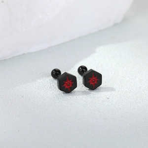 Detailed macro view of black hexagonal screw-back studs with red sun totem pattern