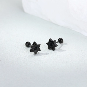 Macro detail of black stainless steel hexagram stud earrings with center black zircon
