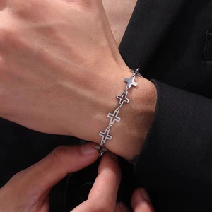 Polished titanium steel bracelet featuring hollow cross links worn on a wrist
