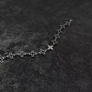 Detailed macro view of hollow cross links on titanium steel bracelet with cold metal finish