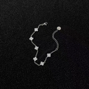 Detailed macro view of silver titanium steel chain bracelet with white cross charms