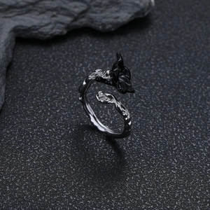 Close-up of gothic floral open ring in silver and black metal on stone texture