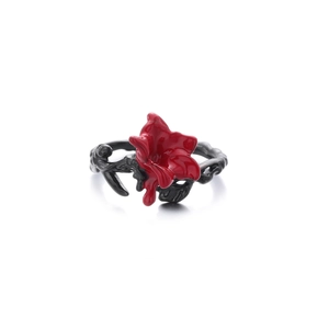 Detailed close-up of gothic thorn ring with dark black band and fluid red enamel flower