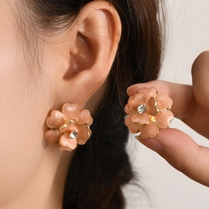 Pink enamel flower stud earrings with gold plating and central crystal accents for women