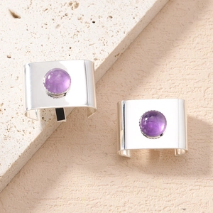 Detailed close-up of bohemian silver hair buckles featuring purple amethyst inlay