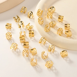 Macro detail of hollow golden metal hair rings and accessories for braids decoration