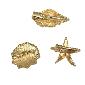 Three-piece gold sea shell and starfish hair clips with durable metal duckbill back