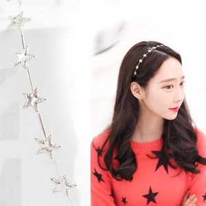 Detailed macro view of thin metal headband with star-shaped accents in gold and silver