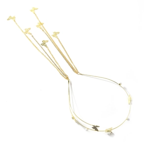 Golden butterfly tassel headband with white pearl accents on elegant metallic hair hoop