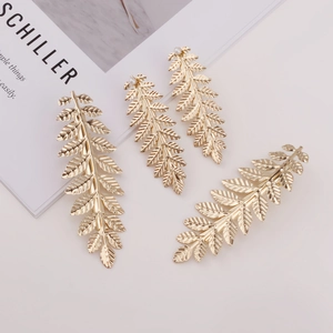 4-piece set of gold leaf hair clips featuring metallic textures and pearl accents