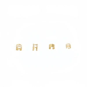 Detailed view of four golden hollow C-shape hair ring accessories with smooth and X-shaped designs