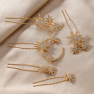 Detailed view of five gold hairpins with moon and stars featuring inlaid white rhinestones