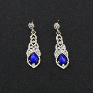 Elegant silver tassel earrings with round floral crystals and pear-shaped blue drop stones