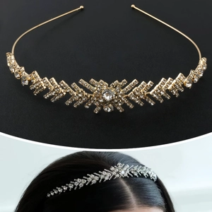 Elegant gold bridal tiara with sparkling rhinestones and crystal accents on black background