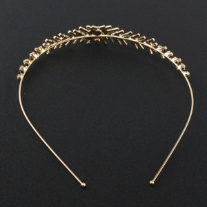 Detail view of the golden bridal headband showing intricate branch structure and rhinestones