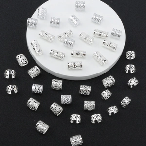 40pcs silver hollow hair rings for braids set on a white stand with black background