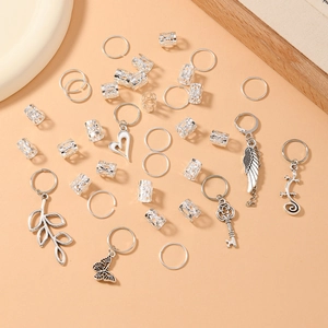 Detail shot of silver leaf dreadlock hair rings with butterfly and wing pendants