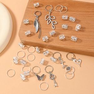 36-piece silver leaf dreadlock hair ring set with vintage alloy charms on wood background