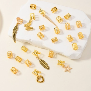 Set of 26 gold leaf dreadlock jewelry rings with charms including butterfly and stars