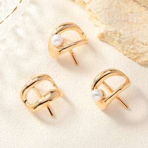 Close-up of golden irregular metal hair clips and pins featuring elegant white pearls