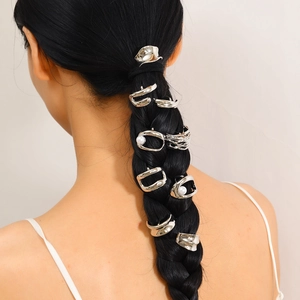 Silver metal hair clips and pearl pins styled on a braided ponytail for elegant women