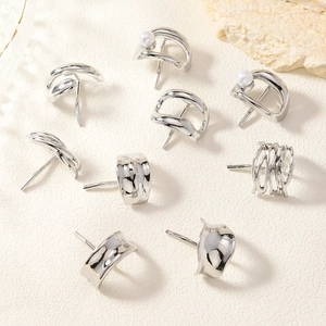 Elegant minimalist silver earring set featuring studs and cuffs with pearl accents