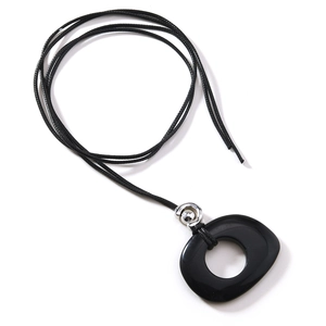 Detail view of polished black obsidian pendant with adjustable leather cord on white background