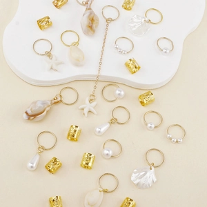 Bohemian gold dreadlock jewelry set with starfish shells and faux pearls on white stand