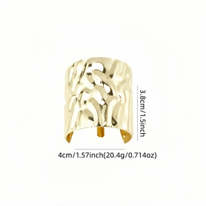 Golden textured wide cuff bracelet with irregular hammered surface and wavy hollow design