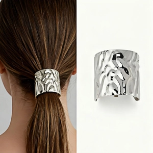 Close-up of silver metal ponytail hair hook with hammered texture for hair styling