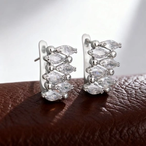 Macro detail of rose gold hoop earrings featuring ten marquise-cut marquise zircon stones