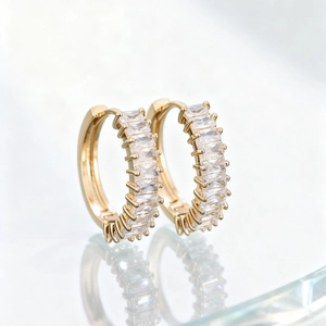 Elegant gold huggie earrings with channel-set rectangular cubic zirconia stones