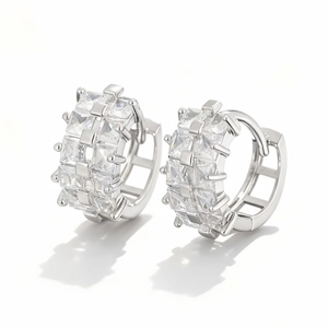 Close-up of silver hoop earrings with square-cut clear cubic zirconia channel setting