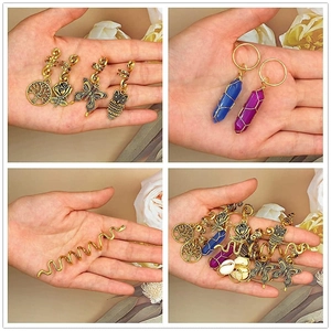 Detailed macro view of gold plated tree of life and gemstone pendants for dreadlocks