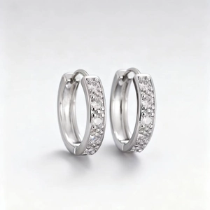 Silver copper hoop earrings featuring five micro-pave cubic zirconia stones in huggie style