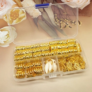 Detailed set of gold braid rings and leaf pendants in a clear plastic storage box