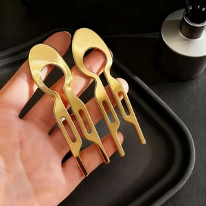 Minimalist gold U-shaped fish hair fork for bun styling with waterdrop hollow design